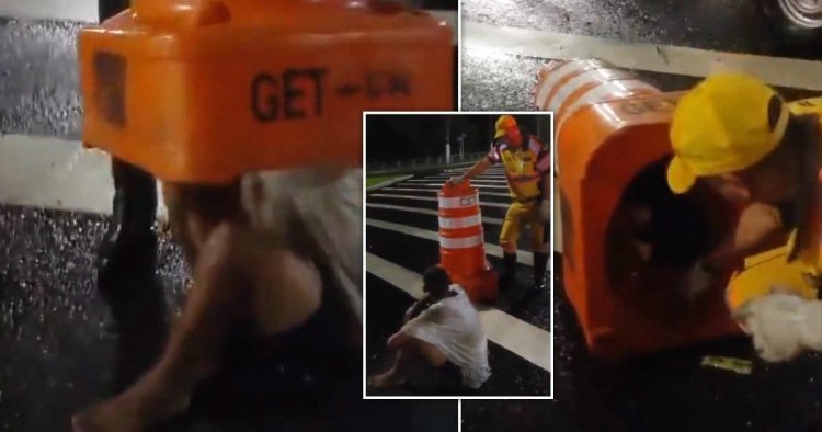 Bizarre moment man is rescued after getting wedged inside traffic cone